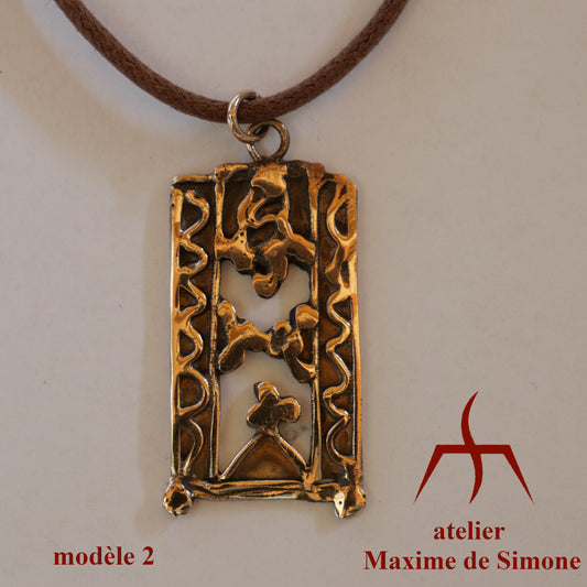 Pendentif en bronze découpé, décoré de motifs soudés