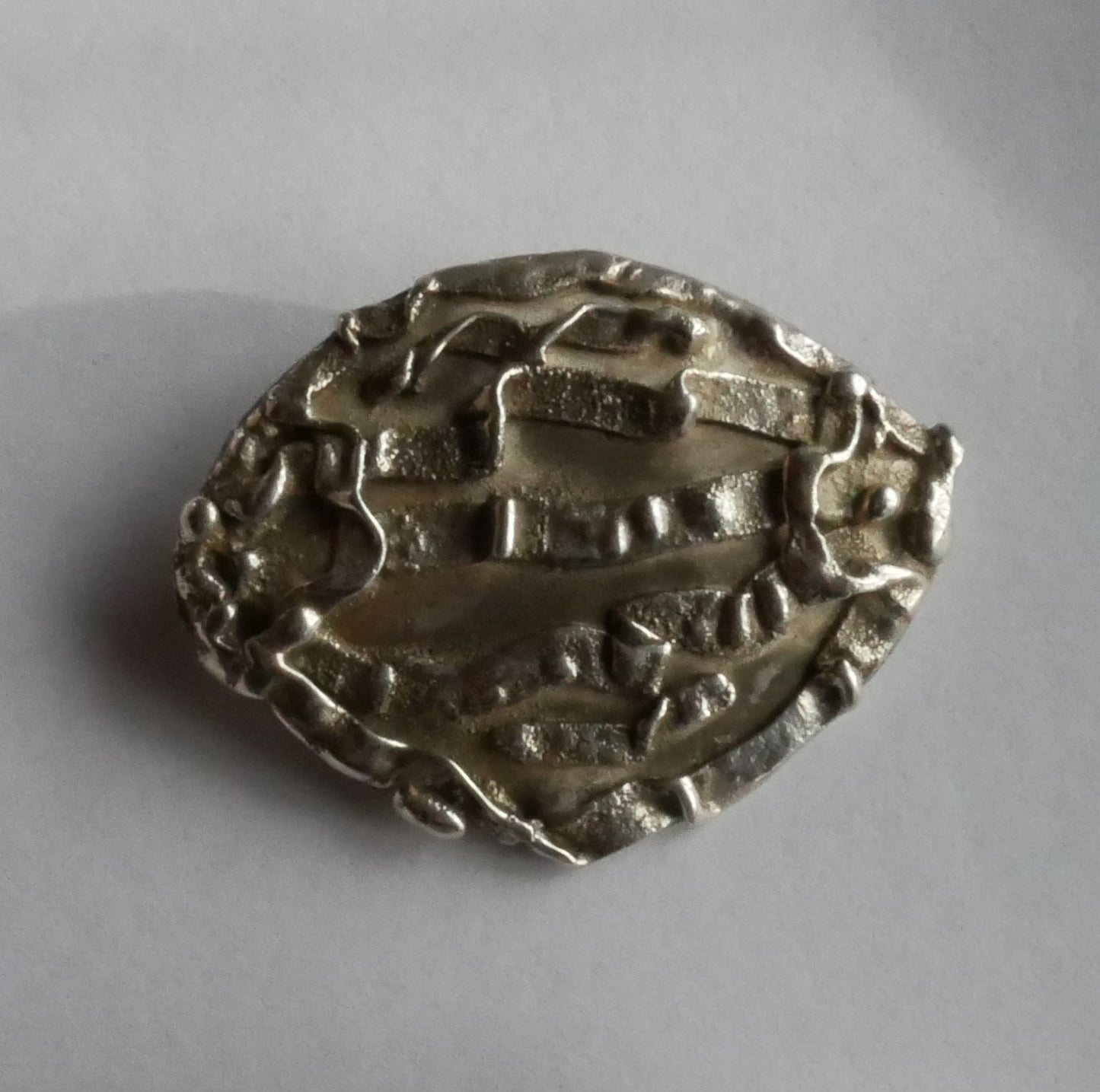 broche ovale en argent sculpté