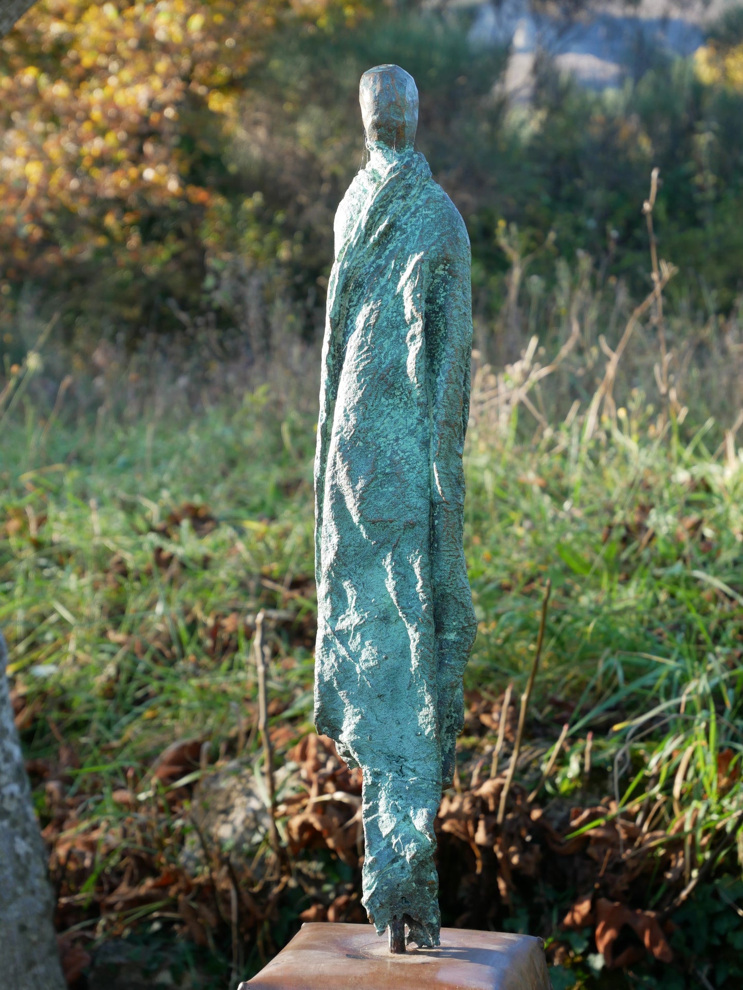 green weathered draped figure