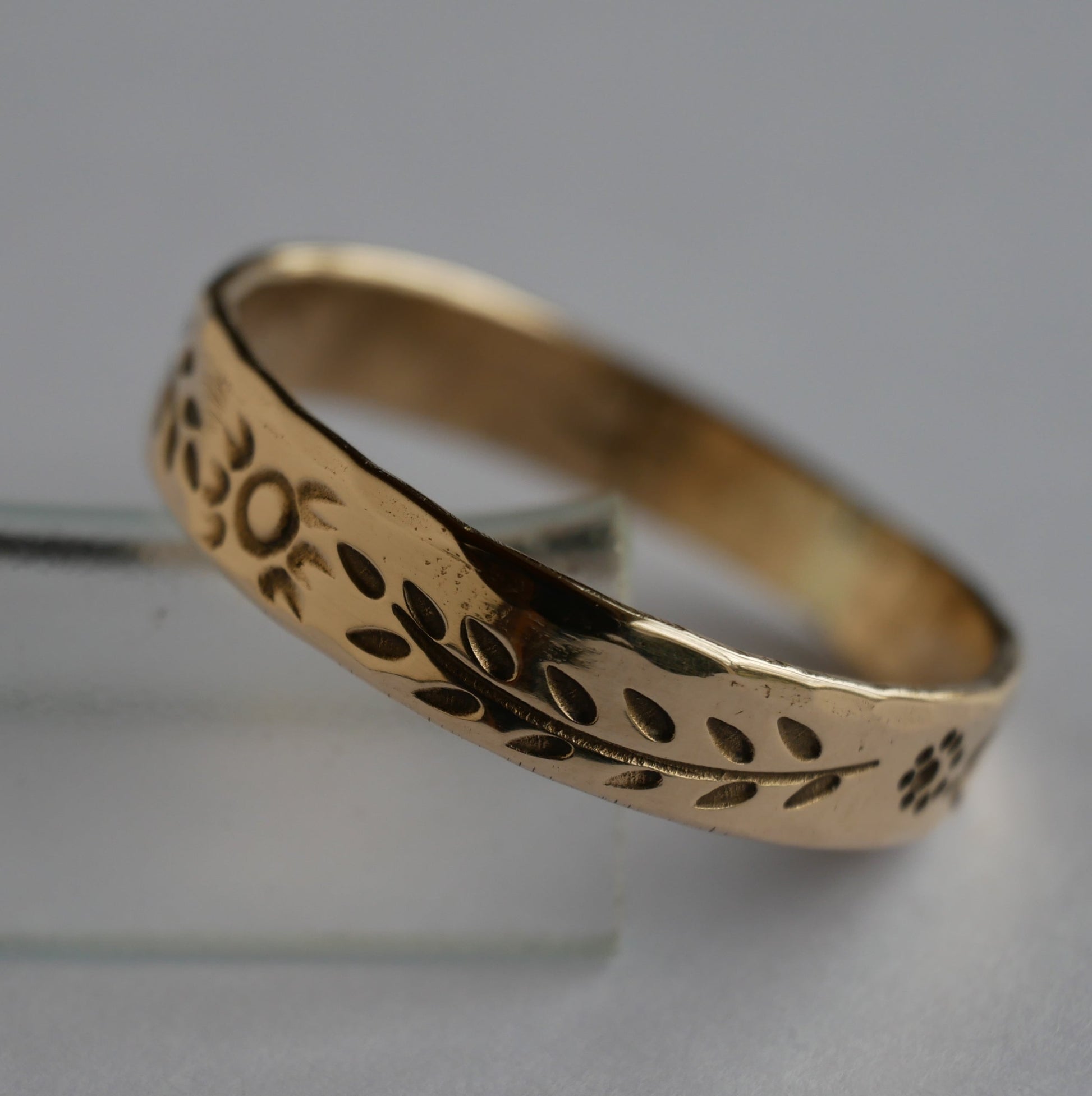 bague en bronze gravée de motifs végétaux et solaires