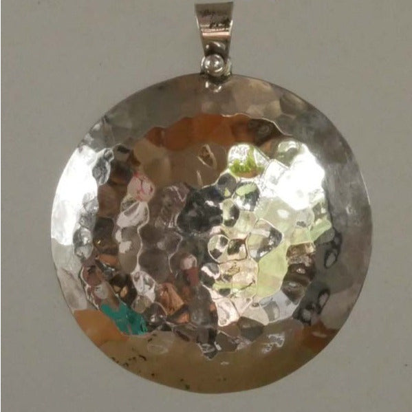 circular pendant in hammered silver